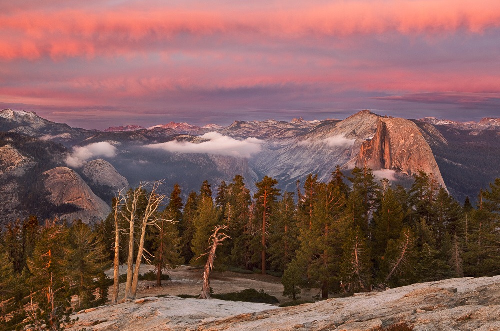 A two-mile run from Taft Point to Sentinel Dome left us out of breath but enthusiastic about capturing what promised to be a spectacular sunset. Earlier my workshop client and I had been working at Taft when I noticed high clouds filling the sky with texture and definition, and a gap below the clouds on the western horizon—ideal conditions for dynamic light. Photographers are always trying to predict when a good sunset will appear, and it’s usually a futile effort. This day, however, the odds seemed to be in our favor, making the run worthwhile. I found a pleasing scene halfway up the dome and left the camera and tripod in place while working with my client on his photography. Over the next twenty minutes, we were treated to a most stunning light show, and I occasionally ran back to my camera and captured a few frames.