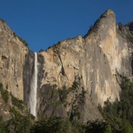 An impressive granite rock feature with cascading Bridalveil waterfall from the floor of Yosemite Valley.