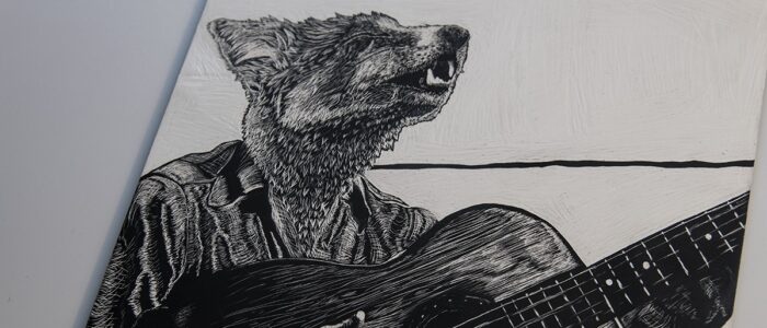 Scratchboard artwork of a coyote playing a guitar