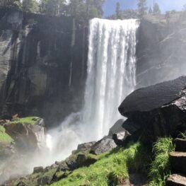 The wide Vernal Falls drops down into clouds of mist as viewed from the aptly named Mist Trail. 