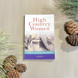 Sitting in the foliage is the book High Country Women featuring two women on the cover of the book. 