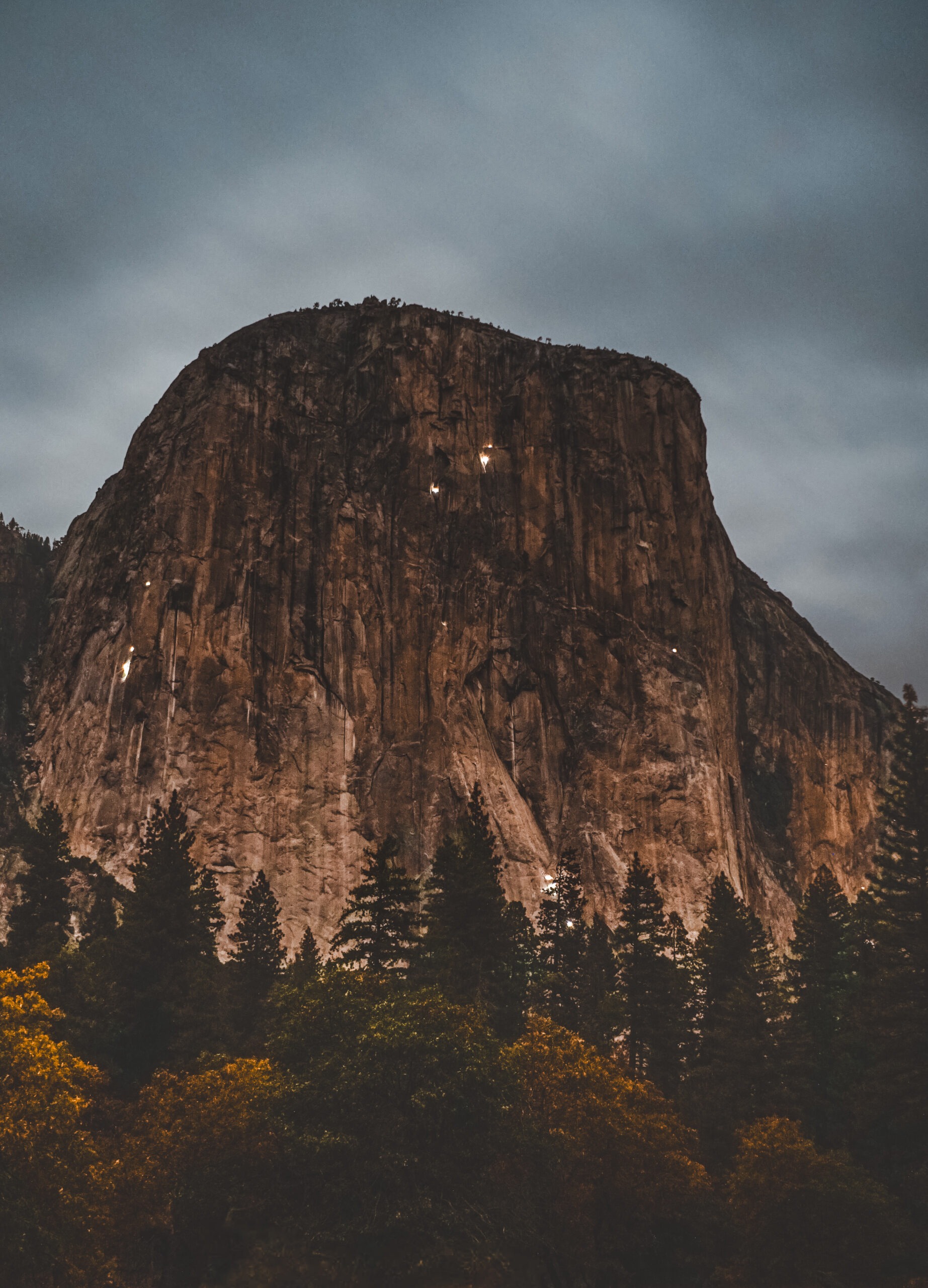 photo of climbers flashlights on the wall of el cap at night 
