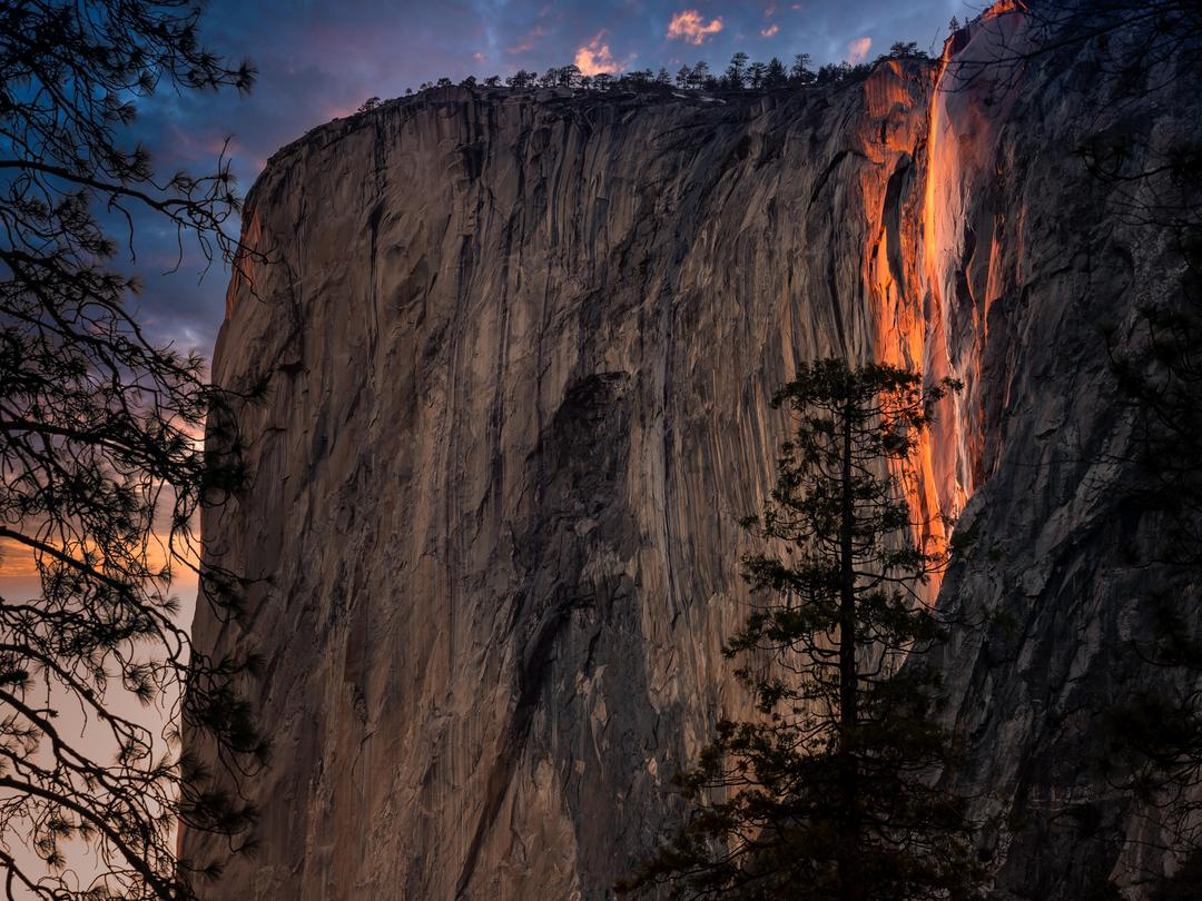 photo of what appears to be glowing fire coming out of a waterfall, which is the firefall horsetail fall phenomena