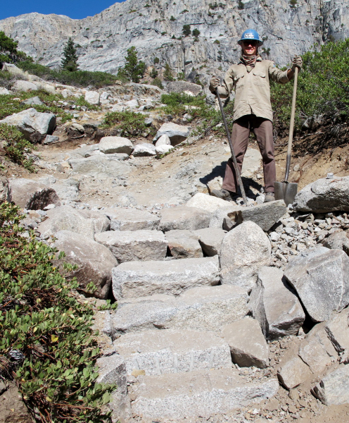 A CCC crew member shows of stone steps taking shape on a backcountry trail in Yosemite.