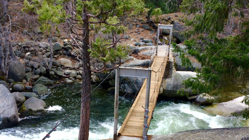 The South Fork Merced River flows under the Wawona Swinging Bridge in southwestern Yosemite in March 2019. Photo: Carolyn Botell