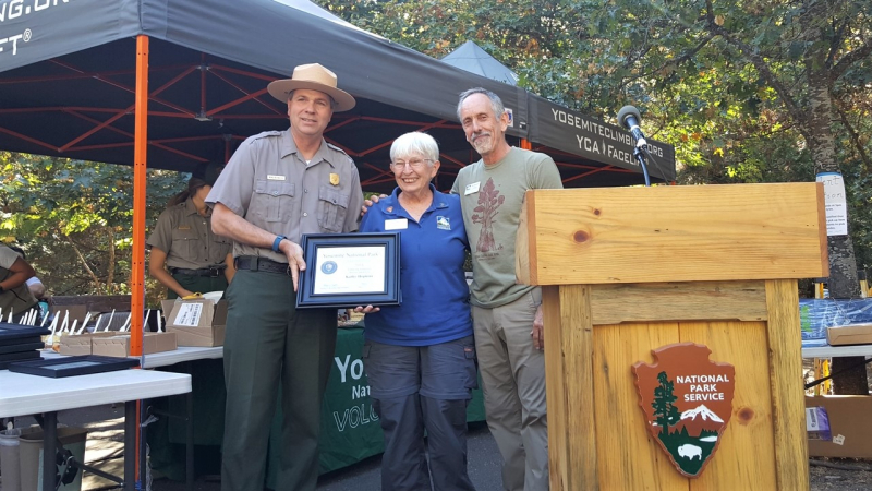 Yosemite National Park Superintendent Michael Reynolds and Yosemite Conservancy Volunteer Program Supervisor Mark Marschall honored Kathy Hopkins, a dedicated Conservancy visitor information assistant, as the park's Enduring Volunteer of the Year. Photo: NPS