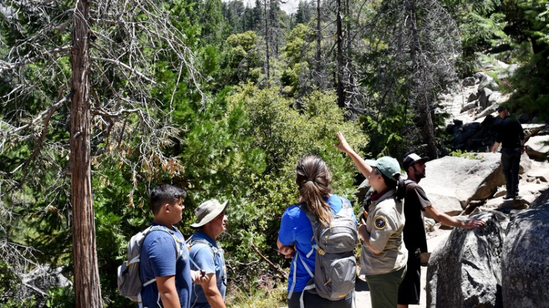 A Yosemite Conservancy volunteer shares hiking and safety tips with visitors on a trail near Nevada Fall. Photo: Yosemite Conservancy/Mark Marschall
