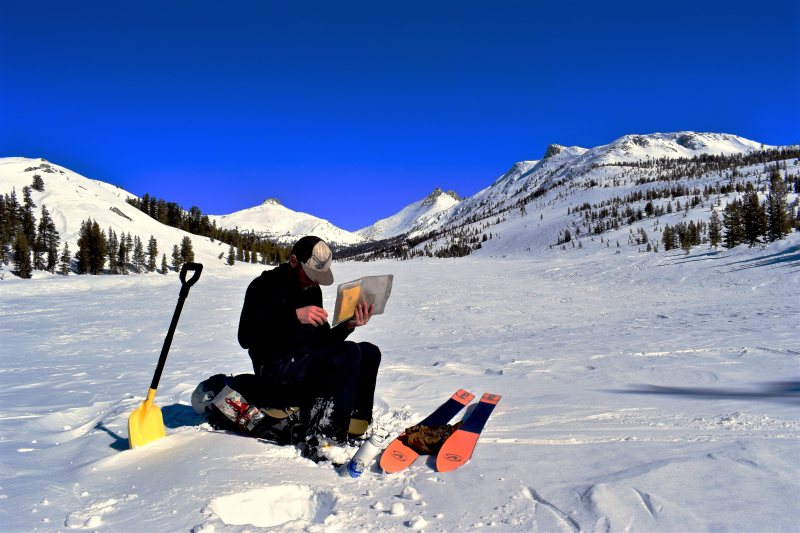 A member of the Sierra Nevada red fox survey team catches up on data entry during a clear day in Yosemite's high country. Photo: Ryan Kelly.