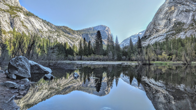 When rain and snowmelt fill Tenaya Creek, reflections of trees and granite features, including Mount Watkins, paint the surface of Mirror Lake. Photo: Jeff Cepek.