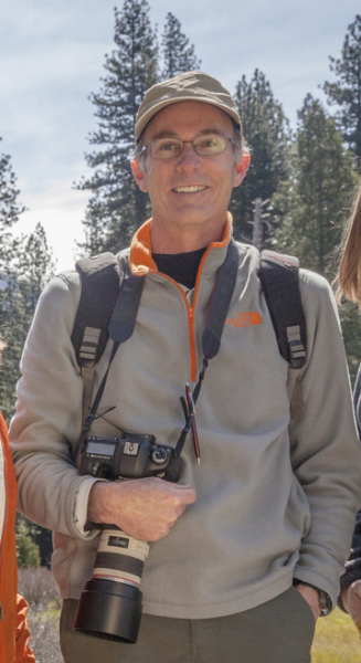 Naturalist Bill King puts down his own lens to smile for the camera in Yosemite Valley. Photo: Yosemite Conservancy/Keith Walklet