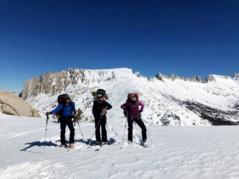 By <strong>day five</strong>, the skies had cleared enough for a team photo op at the top of Mule Pass, with Sawtooth Ridge providing a dramatic backdrop. Pictured (left to right): Brian, Mike and Toren. Not pictured (behind the camera): Ryan.