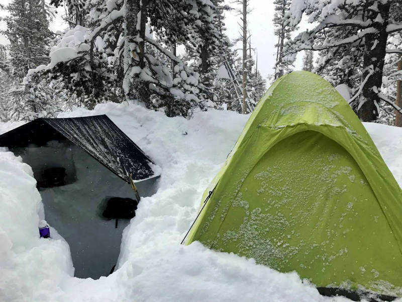 The storm continued overnight, and the crew awoke on <strong>day four</strong> to almost a foot of fresh snow on their tents. Conditions weren’t much better inside Ryan and Mike’s tent – the lightweight, single-wall structure was easy to carry, but limited ventilation meant a constant battle against condensation accumulating and freezing on the interior.</p> <p>Their “storm kitchen tent” (a black tarp anchored over a deep shoveled-out hollow) offered ample air flow, and allowed them to melt snow and cook meals despite the continuous precipitation. Glamorous? No. Functional? Sure.</p> <p>
