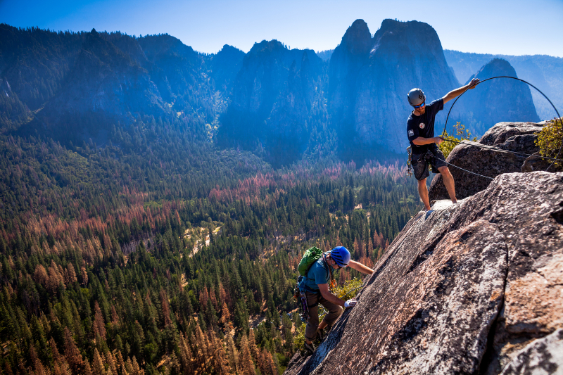 Yosemite's Climber Stewards help build connections with climbers from around the world. Here, Chris belays an attendee of the American Alpine Club International Climbers' Meet on the Nutcracker. Photo: Courtesy of NPS