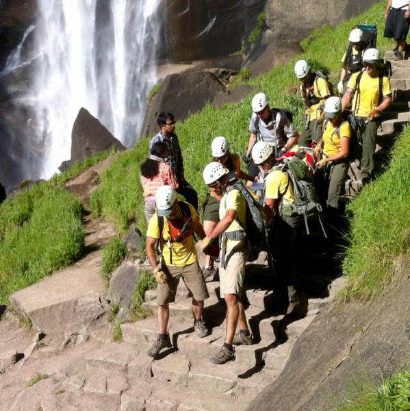 Teamwork in action on one of Yosemite's most popular summer hikes: PSAR, SAR and Student Conservation Association representatives work together to carry out an injured hiker on the Mist Trail. Photo: NPS