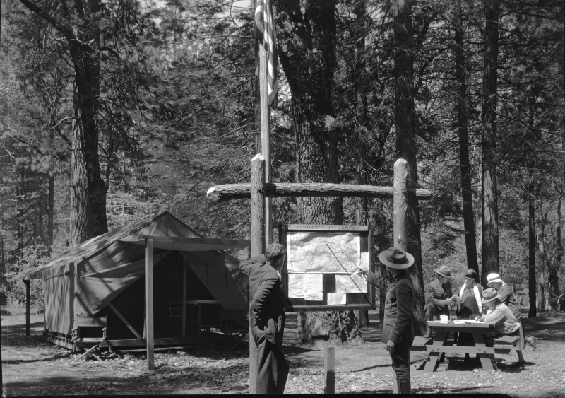 A park ranger and visitors at a campground in Yosemite (year unknown). Photo: Courtesy of NPS (Yosemite Research Library RL-09,418)